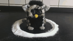 A gif of a Furby trapped in a salt circle
