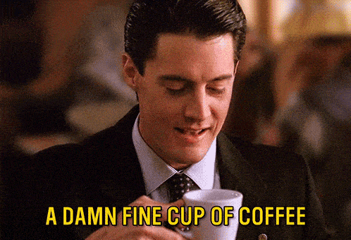 A man drinking a cup of coffee with the text, "A damn fine cup of coffee."