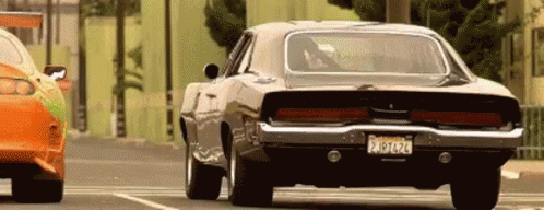 A gif from the Fast and the Furious. Two cars racing.