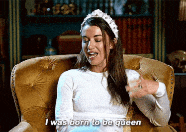A woman sitting in a chair saying "I was born to be queen"