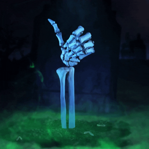A stop-motion skeleton hand rises from glowing misty green goo and gives a thumbs up.