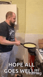 a man in a kitchen flipping a frying pan, and its handle snaps off