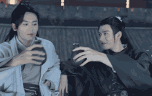 gif of Wen Kexing and Zhou Zishou cheersing alcohol