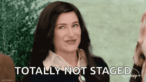 A woman winking and laughing with the text 'totally not staged'