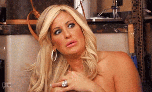 a blond woman looking shocked