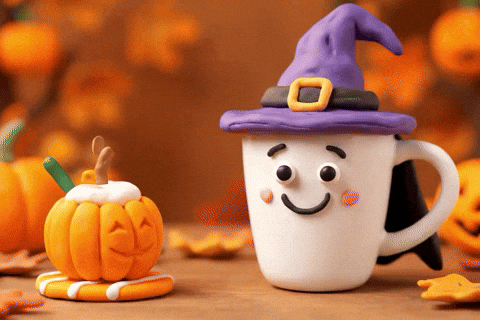 A claymation animation of a mug wearing a witch hat. It reaches out toward a smiling jack o'lantern and picks up a slice of it, as it smiles.