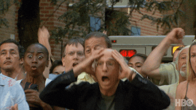 Gif reaction of Larry David from Curb Your Enthisiasm cheering with a crowd.