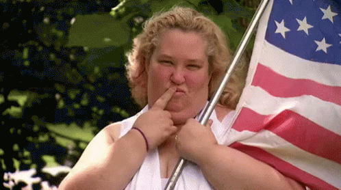 a woman holding an american flag and kissing her finger