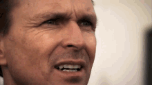 a camera pulls back on a man's face; he looks shocked