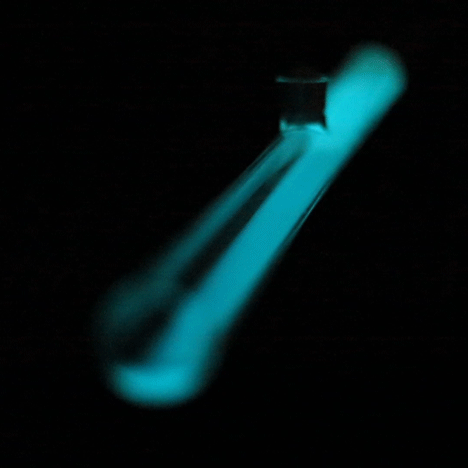 A swinging glass tube containing bioluminescent bacteria