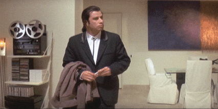 A man in a black suit looking around confused (aka the meme of John Travolta in Pulp Fiction)