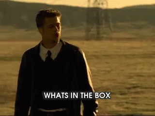 a man standing in a field with the words "what in the box"