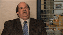 a man in an office saying "Well, guess what? I WILL NOT do a good job"