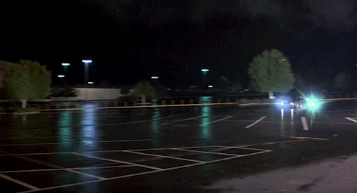 An animated gif of the Delorean car from "Back to the Future" speeding across an empty mall parking lot and disappearing in an explosion of smoke.