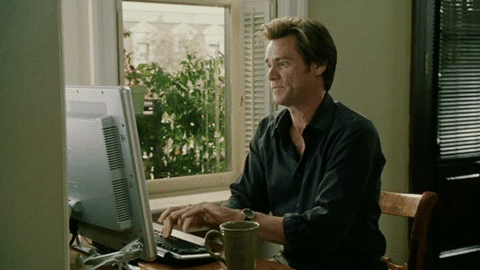 Jim Carrey types furiously on a computer