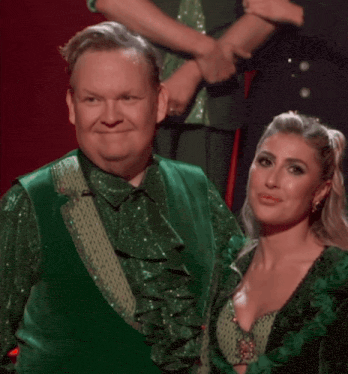 a man and woman dressed in green reacting with shock