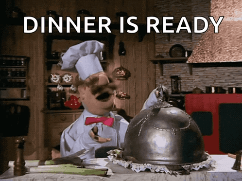 The Muppet's Swedish Chef lifts a metal cover to reveal a puppet chicken, with the words DINNER IS READY