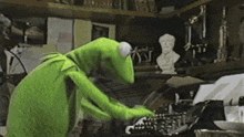 a green frog typing on a typewriter