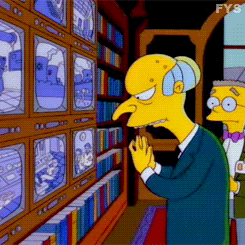 Mr. Burns, the wealthy and unscupulous business owner from the Simpsong, watching several TV screens.