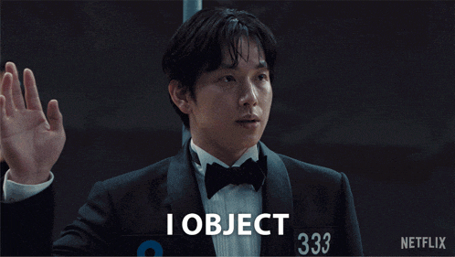 a man in a tuxedo holding up his hand and saying "I object"