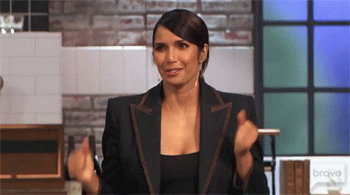 a woman in a kitchen dancing slightly