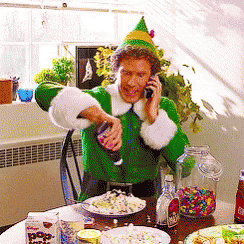 a man dressed as an elf talking on a cell phone