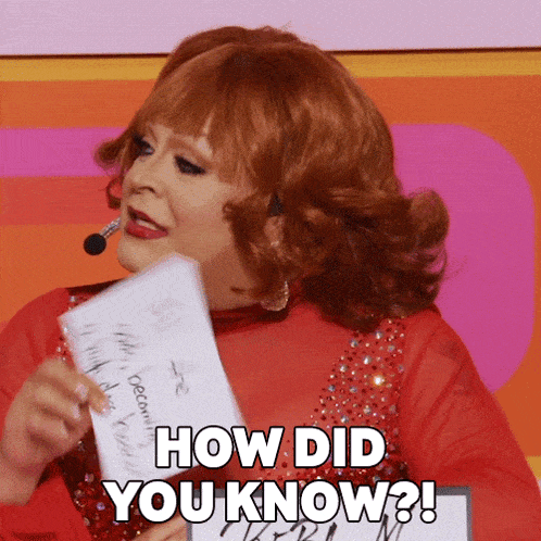 A drag queen dressed as Reba McEntire holding up a piece of paper with the caption "how did you know?"