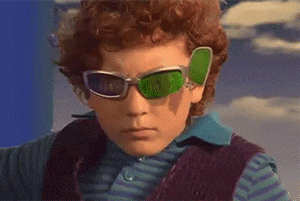A spy kid with spy glasses that have multiple magnificantion lenses.