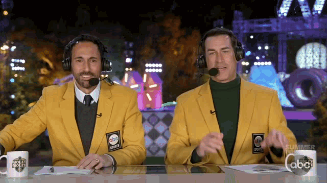 Rob Riggle dancing while sitting, wearing an ABC Sports jacket
