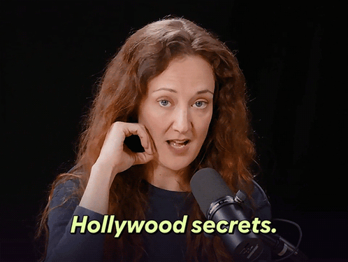 Jackeline Novak is talking into a microphone and the words "Hollywood secrets" are on the screen